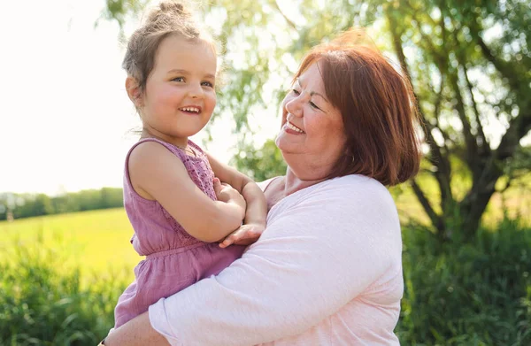 Grandmother spending time with littledaughter during the day — Stock Photo, Image