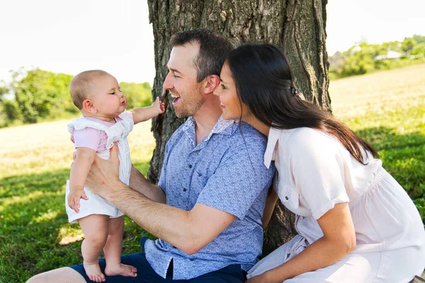 Happy and young family relaxing together in nature — Stock Photo, Image