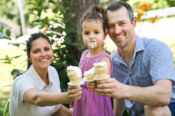 Family with an ice-cream in the park with daughter — Stock Photo, Image