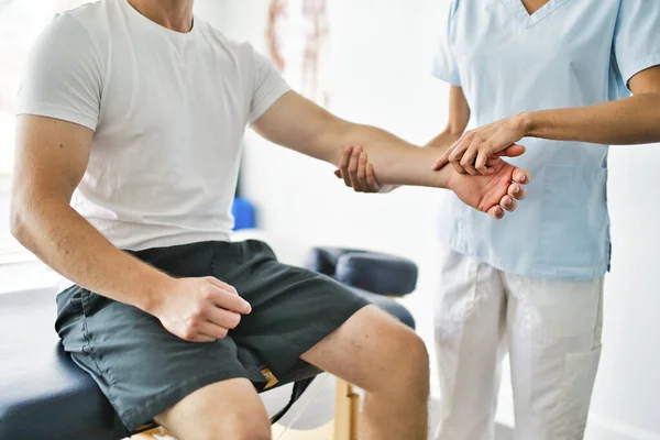 Fysiotherapeut doet behandeling met patiënt in helder kantoor — Stockfoto