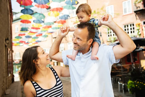 Happy family of three on the street with baby — Stock Photo, Image