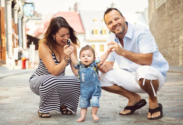 Happy family of three on the street with baby — Stock Photo, Image