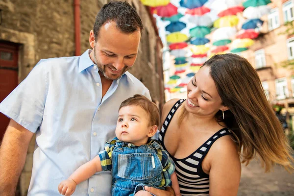 Happy family of three on the street with baby — Stock Photo, Image