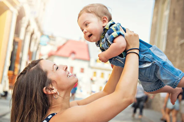 A Mother with her baby son on a urban background — Stock Photo, Image