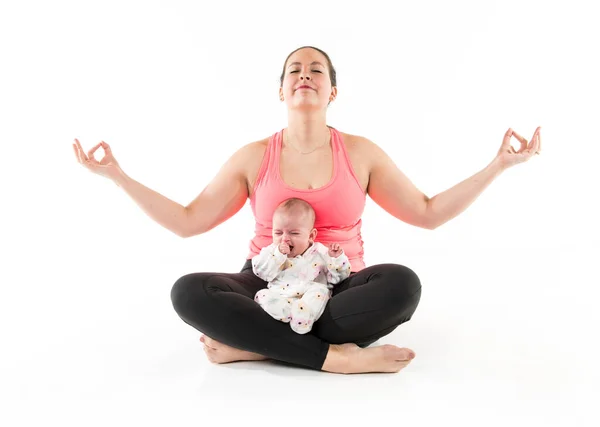 A mother does gymnastics yoga with her baby — Stock Photo, Image