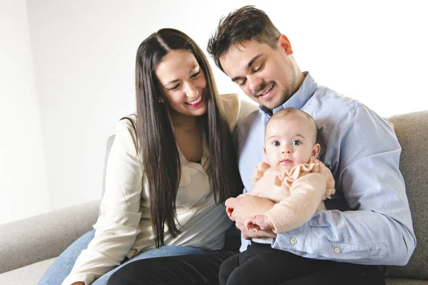 A nice family with baby girl on the sofa — Stock Photo, Image