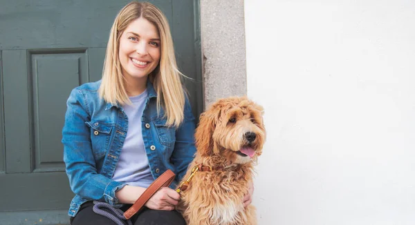 Labradoodle Dog and woman outside on balcony