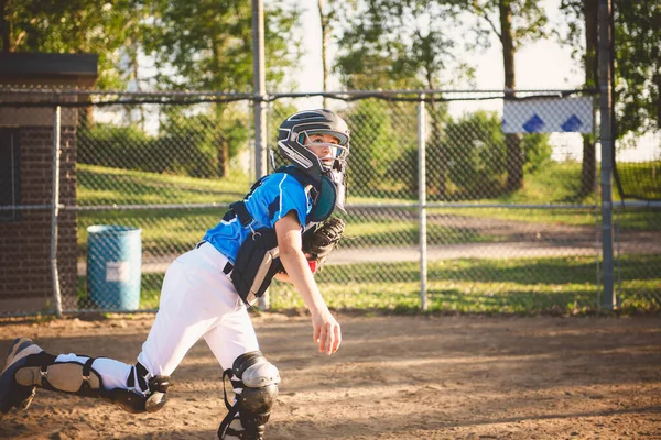 A children baseball catcher players standing on the playground