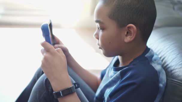 A black boy with tablet in the living room at home — Stock Video