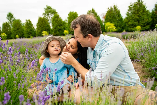 Happy family mother, father and daughter having fun in lavender field — Stock Photo, Image