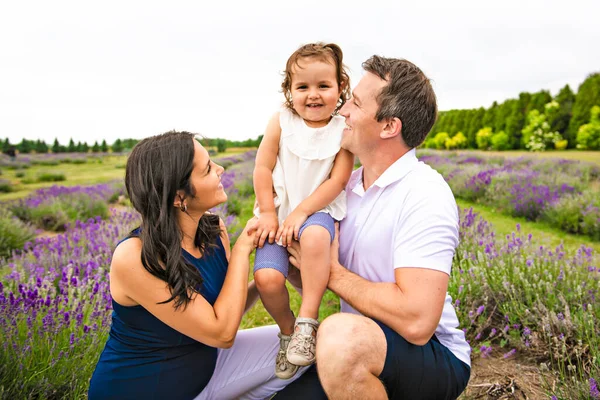 Happy family mother, father and daughter having fun in lavender field — Stock Photo, Image