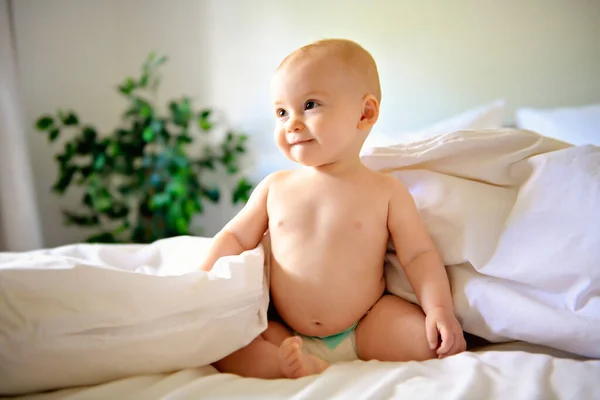 Niedliche glückliche Baby-Mädchen in Windel auf dem Bett — Stockfoto
