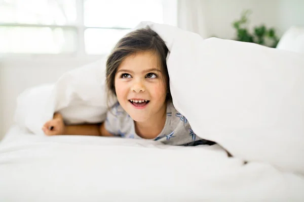 A Portrait of little girl on bed in early morning — Stock Photo, Image