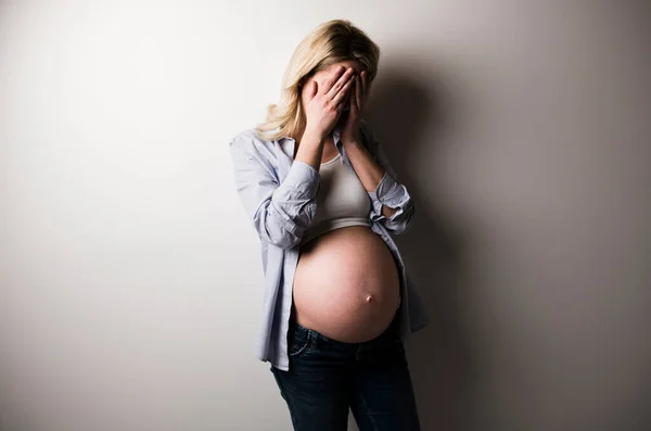 Pregnant woman with a lot of stress on white background — Stock Photo, Image