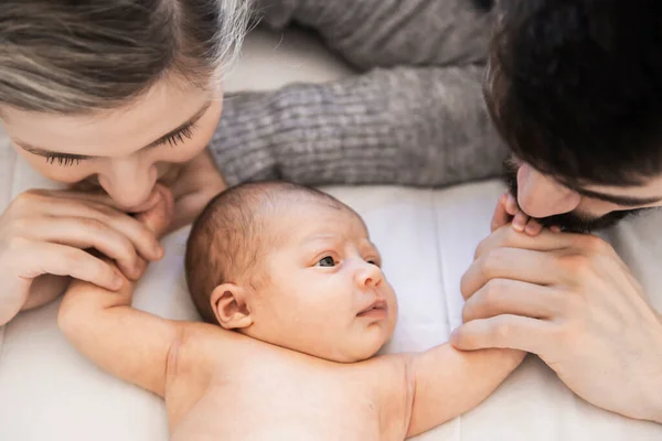 Familia se acostó en la cama con su hija recién nacida — Foto de Stock