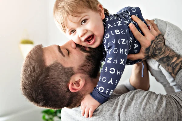 En far og sønn som leker i stua sammen. – stockfoto