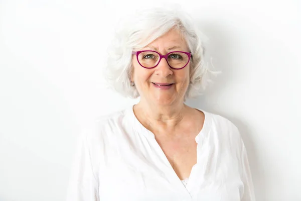 A Senior woman studio isolated on grey wall laughing cheerful — Stock Photo, Image