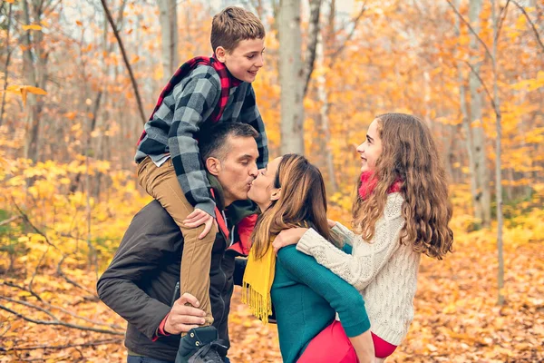 A portrait of a young family in the autumn park — Stock Photo, Image