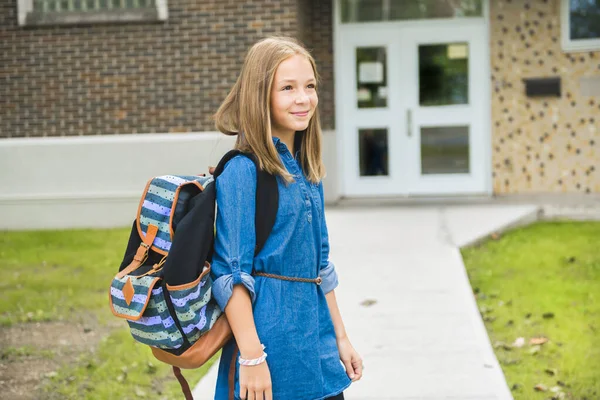 A student school girl on the playground on the first day of class — Stock Photo, Image