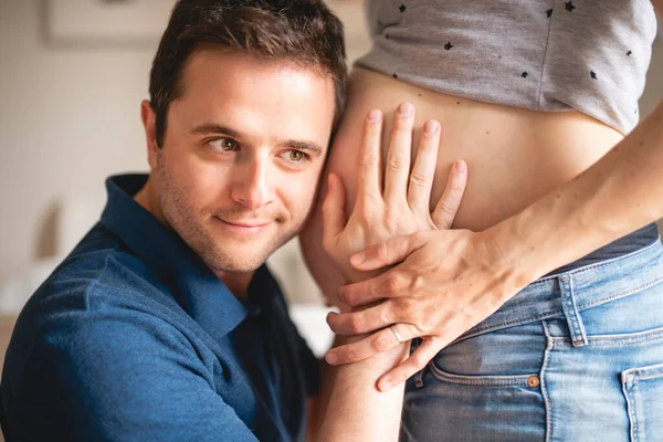 Пара беременных в детской комнате — стоковое фото