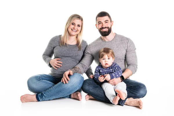 Uma bela família feliz com uma mãe grávida, o pai e um filho juntos — Fotografia de Stock