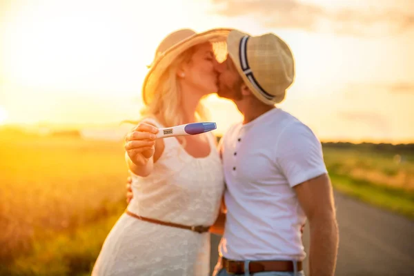 A couple at the sunset with positive baby test — Stock Photo, Image
