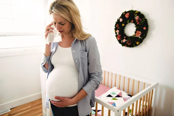 Pregnant woman with a lot of stress at home crying with tissue — Stock Photo, Image