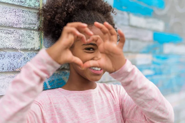 Cheerful african american primary school girl with backpack — Stock Photo, Image