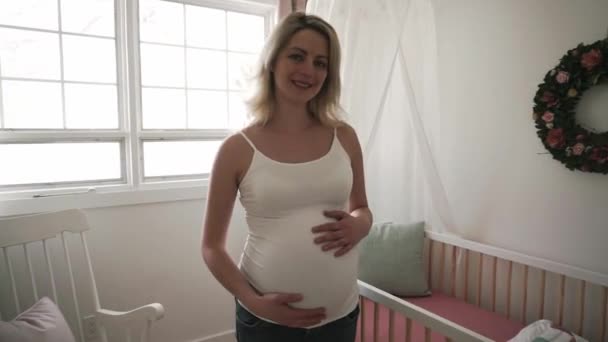 Pregnant woman expecting a baby touching her belly — Stock Video