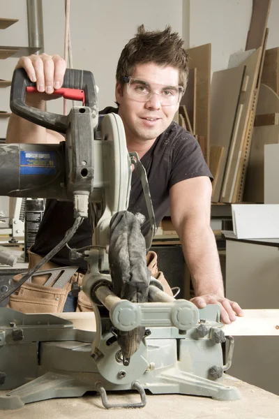 Carpinteiro no trabalho no trabalho usando a ferramenta elétrica — Fotografia de Stock