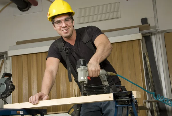 Carpenter at work on job using power tool — Stock Photo, Image