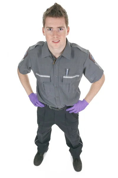 Paramedicus werknemer aan de voorkant van een witte achtergrond — Stockfoto