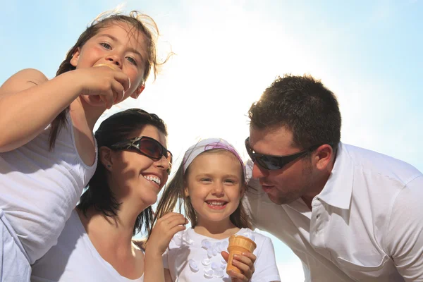 Family eating ici-cream in front of ocean — Stock Photo, Image