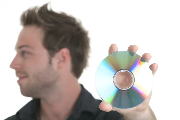 A 30 years old men holding a cd or a dvd — Stock Photo, Image