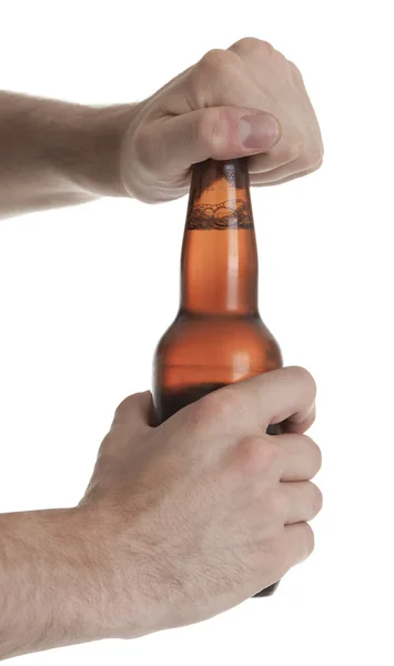 Casual young man holding bottle of beer, smiling. Isolated on wh — Stock Photo, Image