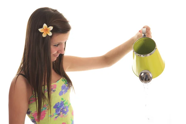 Portrait of a beautiful young woman posing with a watering can — Stock Photo, Image