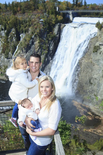 A Cheerful family with waterfall on the background — Stock Photo, Image