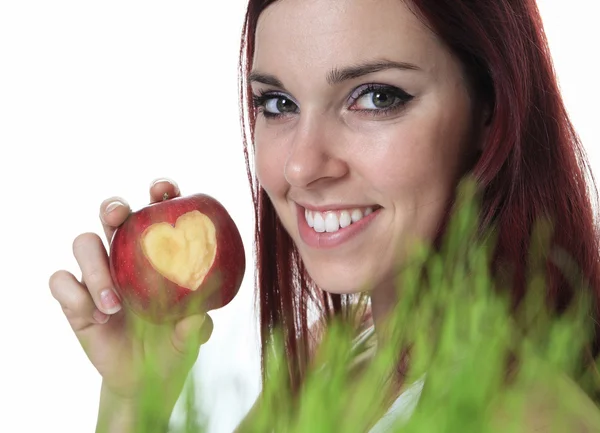 Smiling beauty holding red apple while isolated on white — Stock Photo, Image