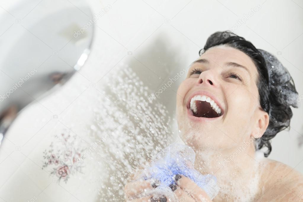 Shower woman. Happy smiling woman washing shoulder showering in — Stock Photo © Lopolo 64988245