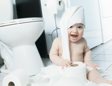 Toddler ripping up toilet paper in bathroom clipart