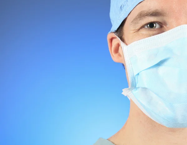 Mature male surgeon gazing and looking at camera at hospital, close up shot — Stock Photo, Image