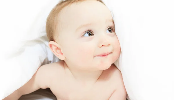 A Baby boy playing on the parent bed — Stock Photo, Image