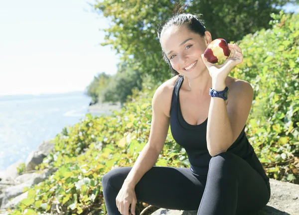 Una donna sportiva felice con una mela — Foto Stock
