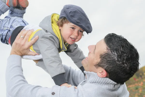 Mutlu baba ve oğul eğleniyor hava çocuk atar. — Stok fotoğraf