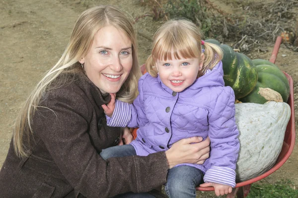 An attractive Mother and Daughter Portrait in Pumpkin — Stock Photo, Image