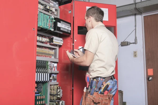 Machinist worker technicians at work adjusting lift with spanner — Stock Photo, Image