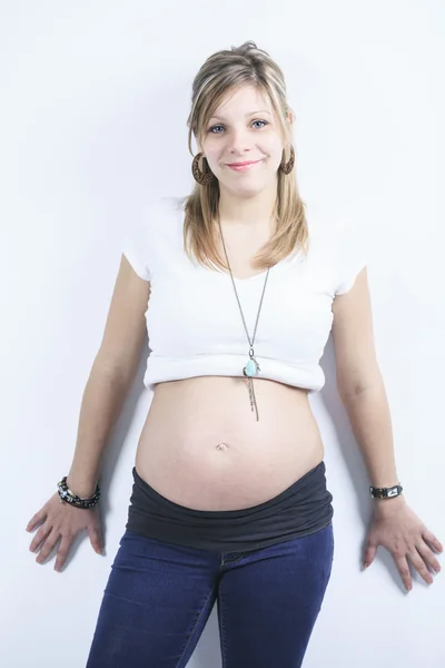 A pregnant woman caressing her belly over white background — Stock Photo, Image