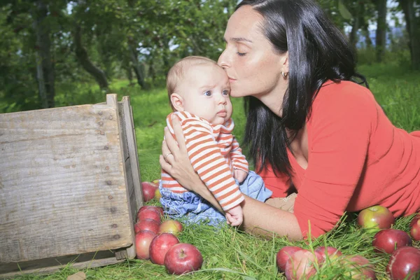 A mother playing with her son on the grass — Stock Photo, Image