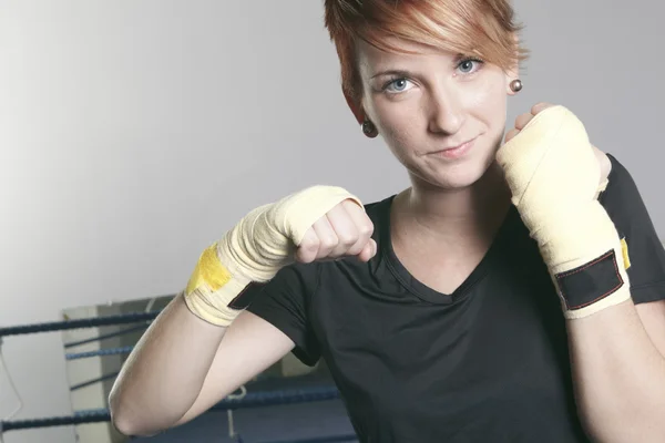 Fitness woman doing punching exercises in training place — Stock Photo, Image