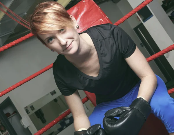 Fitness woman doing punching exercises in training place — Stock Photo, Image